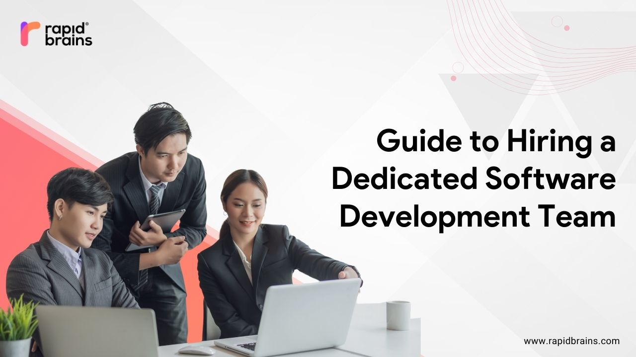 Business team working around a laptop with the text “Guide to Hiring a Dedicated Software Development Team” and RapidBrains branding.